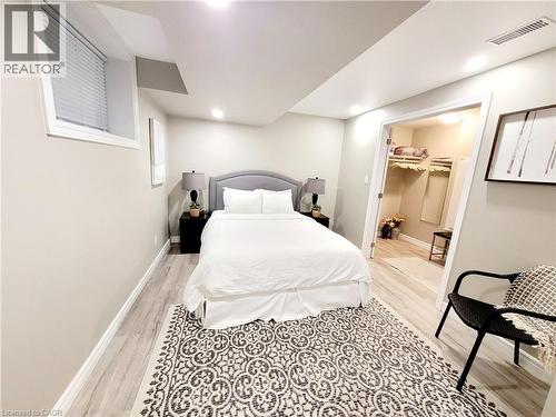 Recessed lighting, wood-finish flooring, and a walk-in closet with built-in shelving - 455 Equestrian Way, Cambridge, ON 