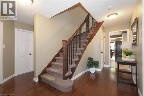 Custom built oak railing and engineered hardwood flooring. - 76 Nith River Way, Ayr, ON 