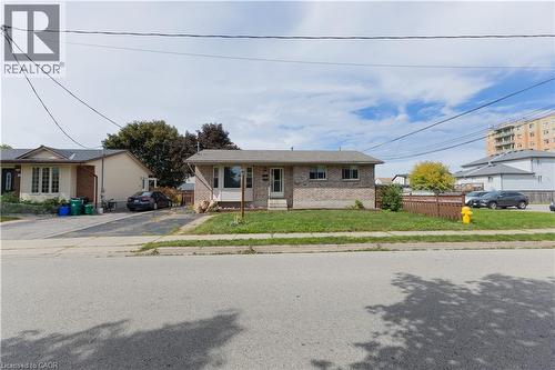 Brick exterior with a gabled roofline and front lawn - 120 Union Street S, Cambridge, ON 