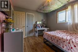 Wood-finish flooring with a multi-pane window and neutral wall color - 