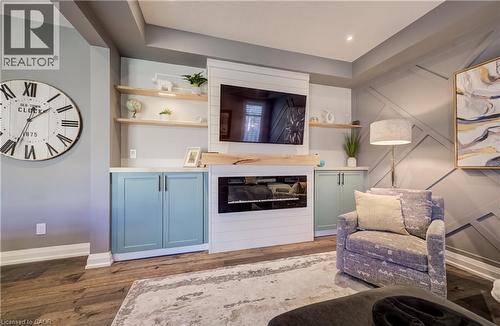 Built-in cabinetry with light blue panel doors, white countertops, and open wood shelving - 35 Greyhawk Street, Kitchener, ON 