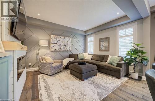 Wood-finish flooring, recessed lighting, and a tray ceiling - 35 Greyhawk Street, Kitchener, ON 