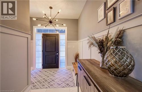 Entry foyer with a dark wood-finish door, transom window, and sidelights - 35 Greyhawk Street, Kitchener, ON 