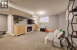 Built-in media console with light wood-finish cabinetry, integrated fireplace, and a floating wood-finish shelf - 