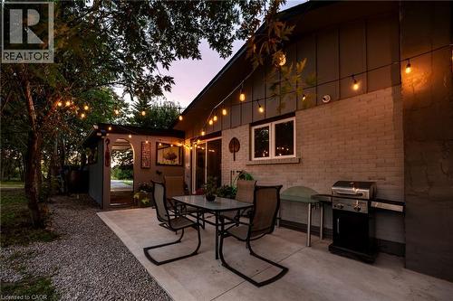 New concrete patio under string lights - 139 Town Line, Orangeville, ON 