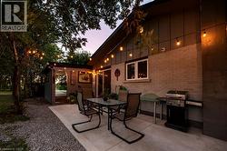 New concrete patio under string lights - 