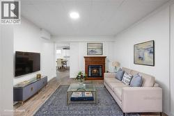 Lower-level living room with fireplace – virtually staged - 