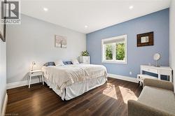 Dark wood-finish flooring, recessed ceiling lighting - 