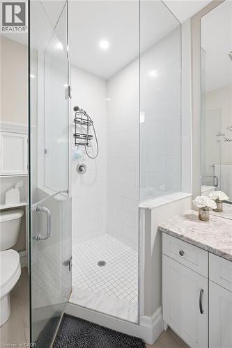 Glass-enclosed shower with mosaic tile floor, and a polished chrome shower system - 192 Brewery Street Unit# 18, Baden, ON 