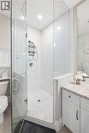Glass-enclosed shower with mosaic tile floor, and a polished chrome shower system - 