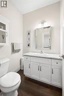 White shaker-style vanity with a light-toned countertop, undermount sink - 