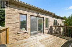 Exterior brick, wood deck, sliding glass door - 