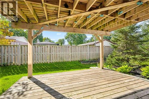 Spacious wood deck with an overhead surrounded by a wood privacy fence and manicured lawn - 192 Brewery Street Unit# 18, Baden, ON 