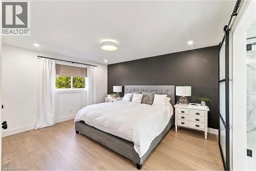 Light wood-finish flooring, recessed lighting, and a modern ceiling fixture - 5367 2 Side Road, Milton, ON 