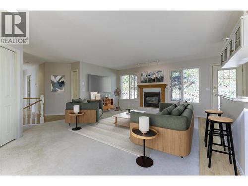 Family room with gas fireplace on the upper level (Virtually Staged) - 4632 / 4624 Minto Street, Peachland, BC 