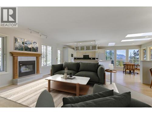 Family room with gas fireplace on the upper level (Virtually Staged) - 4632 / 4624 Minto Street, Peachland, BC 