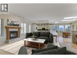 Family room with gas fireplace on the upper level (Virtually Staged) - 