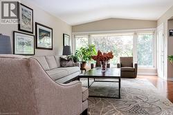 Vaulted ceilings, large picture windows, wood-finish flooring, and crisp white trim - 