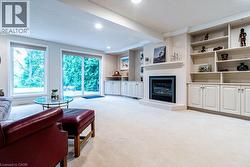 Recessed lighting, built-in shelving, fireplace, large windows, and sliding glass door - 