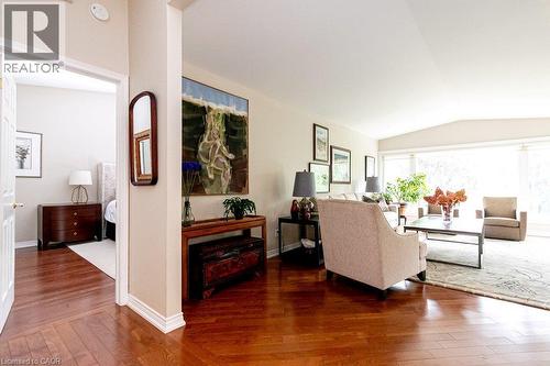 Hardwood flooring, recessed lighting, expansive windows, vaulted ceiling, and an open doorway - 89 Little John Road, Dundas, ON 