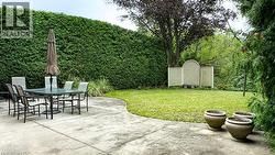 Paved patio with an expansive green lawn - 