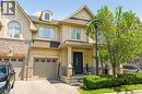 Stucco and stone facade with a prominent dormer window, covered front entry, attached single-car garage, and a paved driveway - 5056 New Street Unit# 4, Burlington, ON 