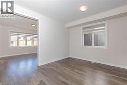 Recessed ceiling lighting, wood-finish flooring, and multiple windows - 