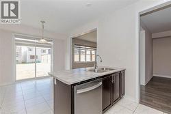 Kitchen island featuring a stainless steel double basin sink and integrated dishwasher - 