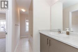 Vanity with integrated sink, polished chrome faucet, and expansive wall mirror - 