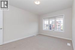 Neutral wall paint, light-toned carpeting, white trim, and a multi-pane window - 