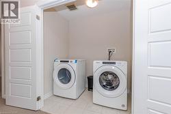 Built-in laundry area featuring tiled flooring - 