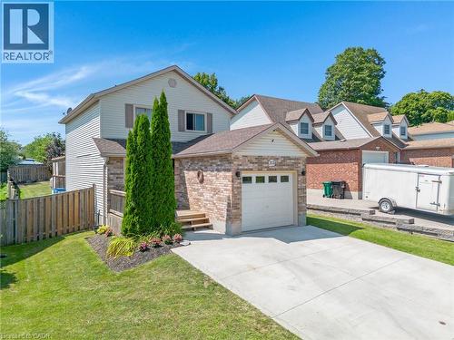 Brick and siding exterior with an attached garage, concrete driveway, and landscaped front yard - 311 Misty Crescent, Kitchener, ON - Outdoor