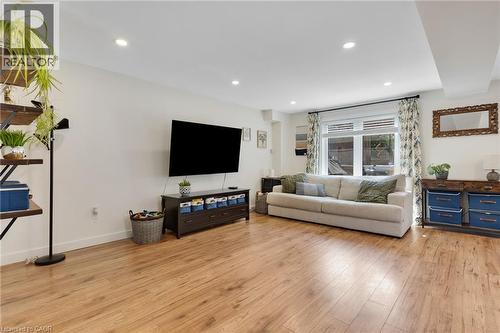 Recessed lighting, wood-finish flooring, and white walls - 311 Misty Crescent, Kitchener, ON - Indoor Photo Showing Living Room