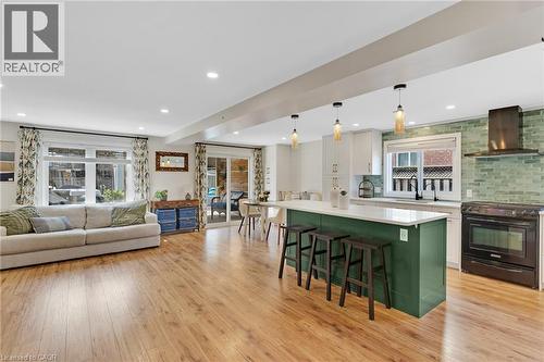 Open-concept living space featuring wood-finish flooring, recessed lighting, and sliding glass doors - 311 Misty Crescent, Kitchener, ON - Indoor