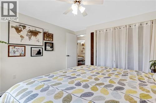 White interior walls with a white ceiling fan and light fixture - 311 Misty Crescent, Kitchener, ON - Indoor Photo Showing Bedroom