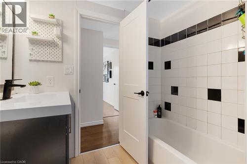 White subway tile shower surround with black accent tiles and recessed niches - 311 Misty Crescent, Kitchener, ON - Indoor Photo Showing Bathroom