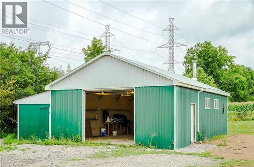Steel-sided outbuilding with a gable roof and roll-up door - 107 6Th Line Line, Haldimand, ON - Outdoor