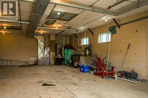 Concrete flooring, exposed ductwork, two windows, recessed lighting, wall-mounted light fixtures - 107 6Th Line Line, Haldimand, ON - Indoor Photo Showing Garage