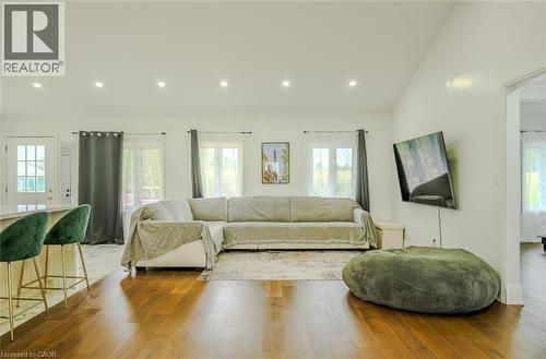 Bright interior with rich wood-finish flooring, recessed ceiling lighting, and multiple windows - 107 6Th Line Line, Haldimand, ON - Indoor Photo Showing Living Room