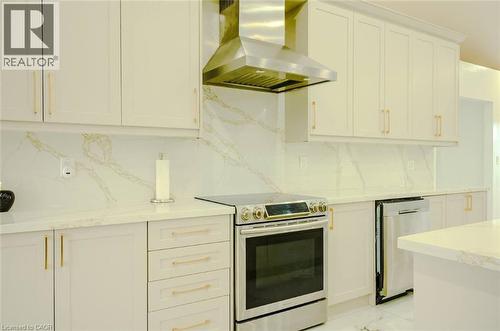 White cabinetry with gold-tone hardware, stainless steel appliances, and a range hood - 107 6Th Line Line, Haldimand, ON - Indoor Photo Showing Kitchen