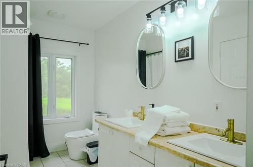 Dual vanity with undermount sinks, gold-finish faucets, and an expansive countertop - 107 6Th Line Line, Haldimand, ON - Indoor Photo Showing Bathroom