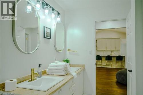Dual vanity with rectangular undermount sinks, gold-finish fixtures, and wall-mounted lighting - 107 6Th Line Line, Haldimand, ON - Indoor Photo Showing Bathroom