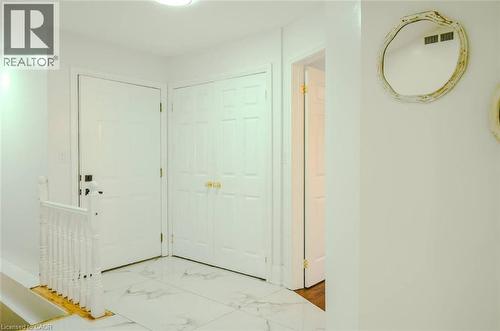 White paneled doors, white walls, and a staircase with white spindles - 107 6Th Line Line, Haldimand, ON - Indoor Photo Showing Other Room