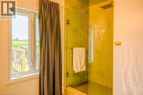 Glass-enclosed shower with a rainfall showerhead, recessed niche, and tiled walls - 107 6Th Line Line, Haldimand, ON - Indoor