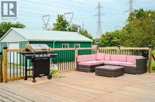 Expansive outdoor wood deck with black metal railings - 107 6Th Line Line, Haldimand, ON - Outdoor With Deck Patio Veranda With Exterior
