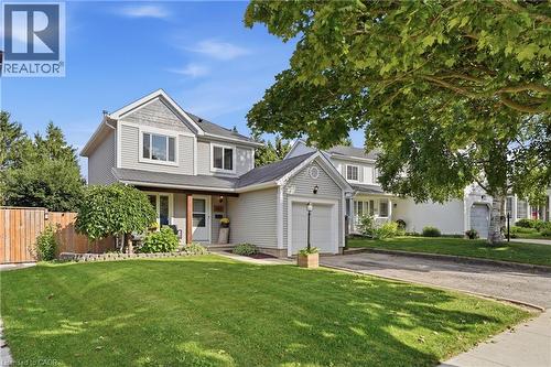 Two-story residence featuring light gray siding with shingle accents and white trim - 563 Westvale Drive, Waterloo, ON - Outdoor With Facade