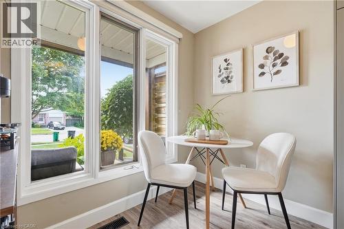 Large windows, light-colored walls, wood-finish flooring, white trim - 563 Westvale Drive, Waterloo, ON - Indoor Photo Showing Dining Room