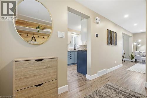 Wood-finish flooring throughout, recessed lighting, and crisp white trim - 563 Westvale Drive, Waterloo, ON - Indoor Photo Showing Other Room