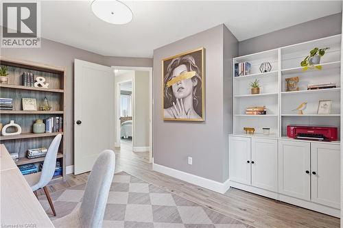 Wood-finish flooring with a textured area rug - 563 Westvale Drive, Waterloo, ON - Indoor Photo Showing Other Room