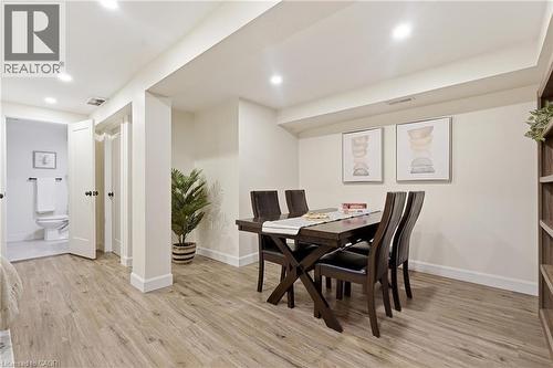 Recessed lighting, wood-finish flooring, white trim, and a built-in shelving unit - 563 Westvale Drive, Waterloo, ON - Indoor Photo Showing Dining Room